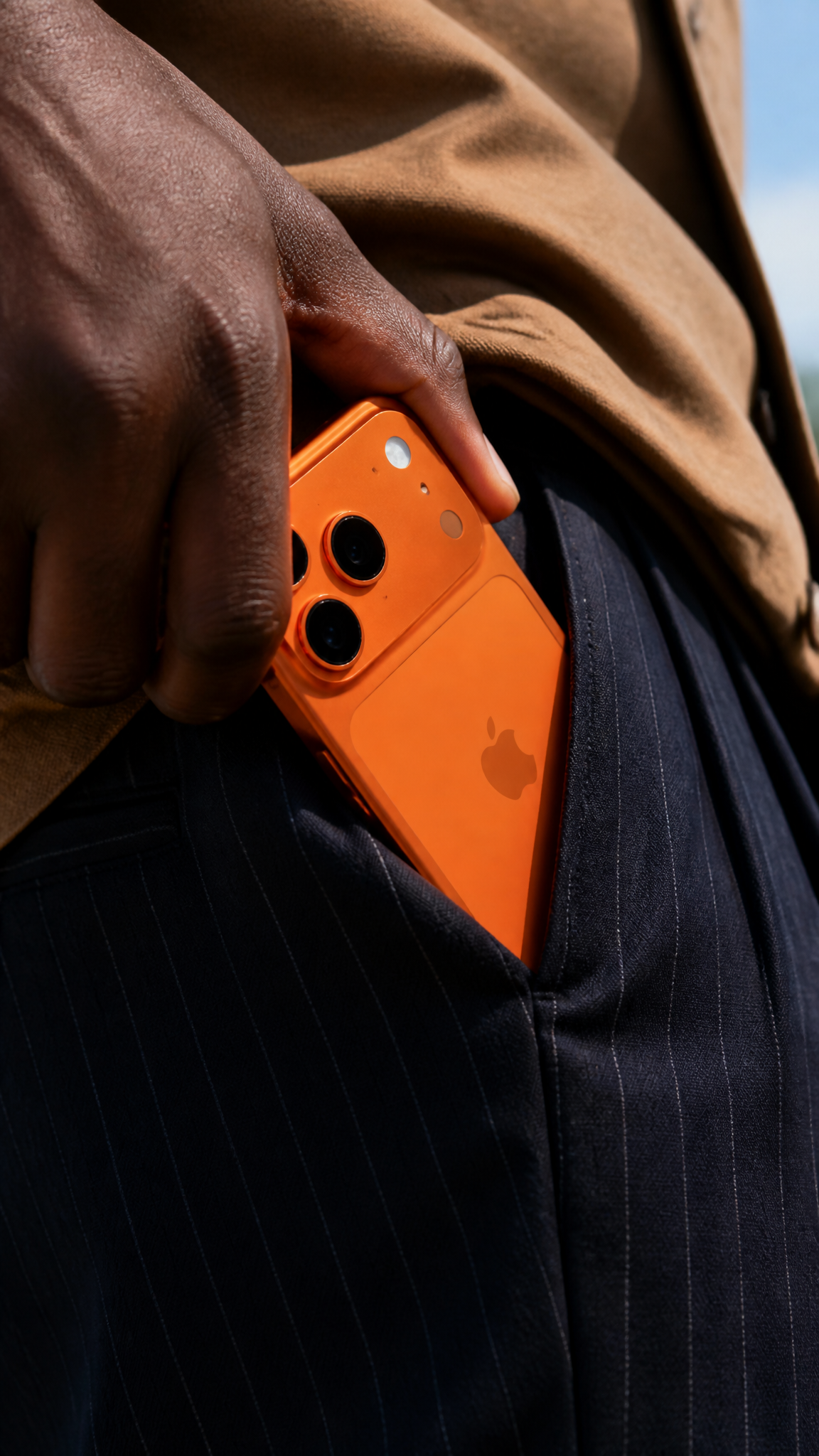 A close-up shot shows a person's dark-skinned hand, likely b