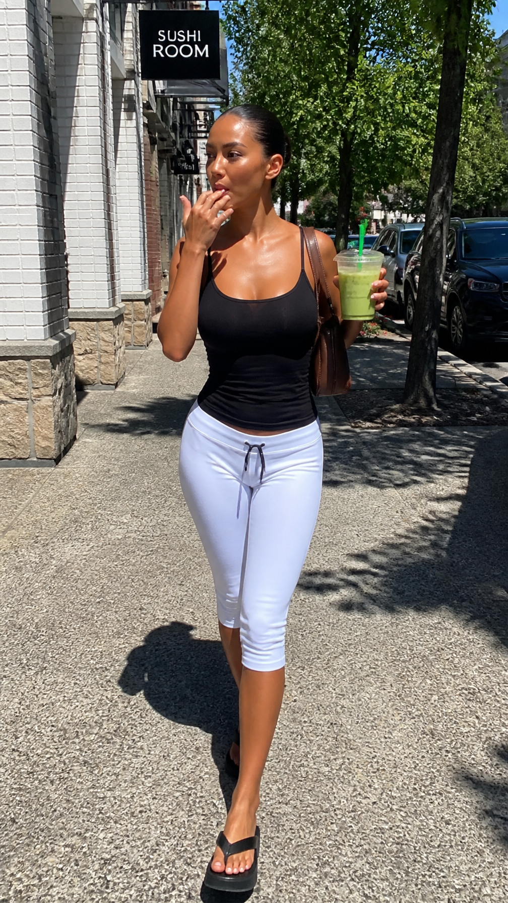 An iPhone-style candid full-body street-style shot of a youn