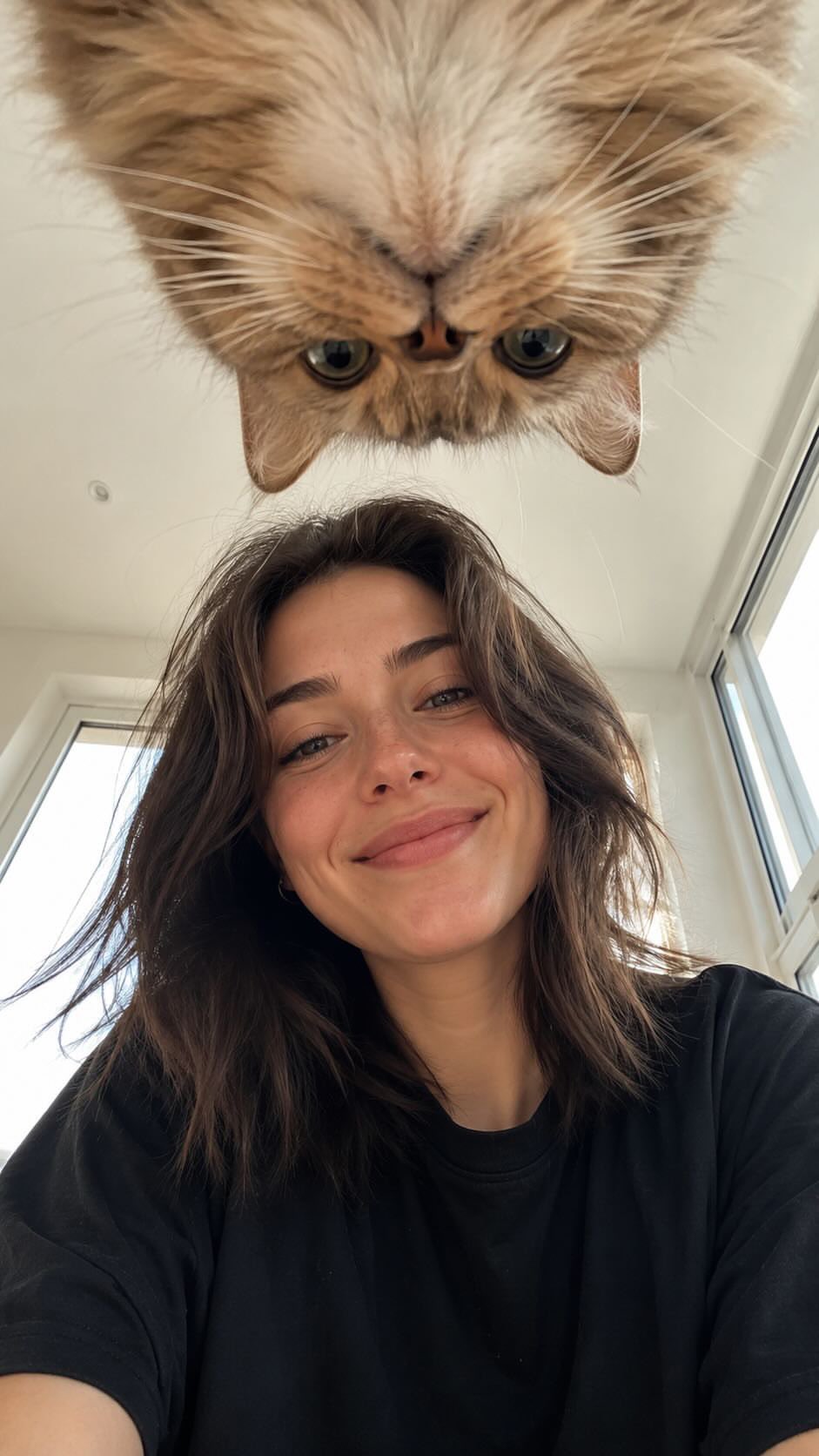 Create a realistic vertical smartphone selfie taken indoors 
