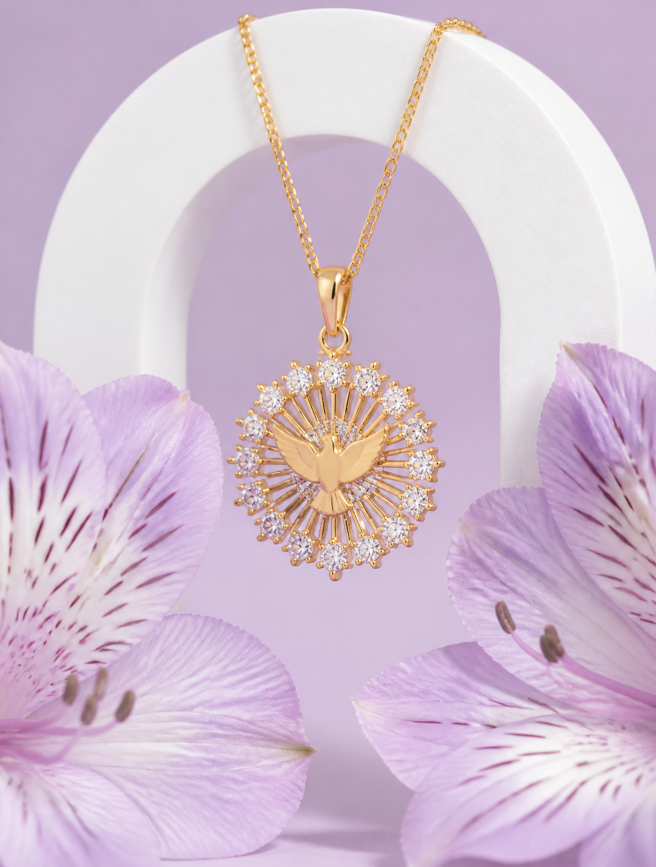 A delicate gold pendant featuring a central dove motif surro