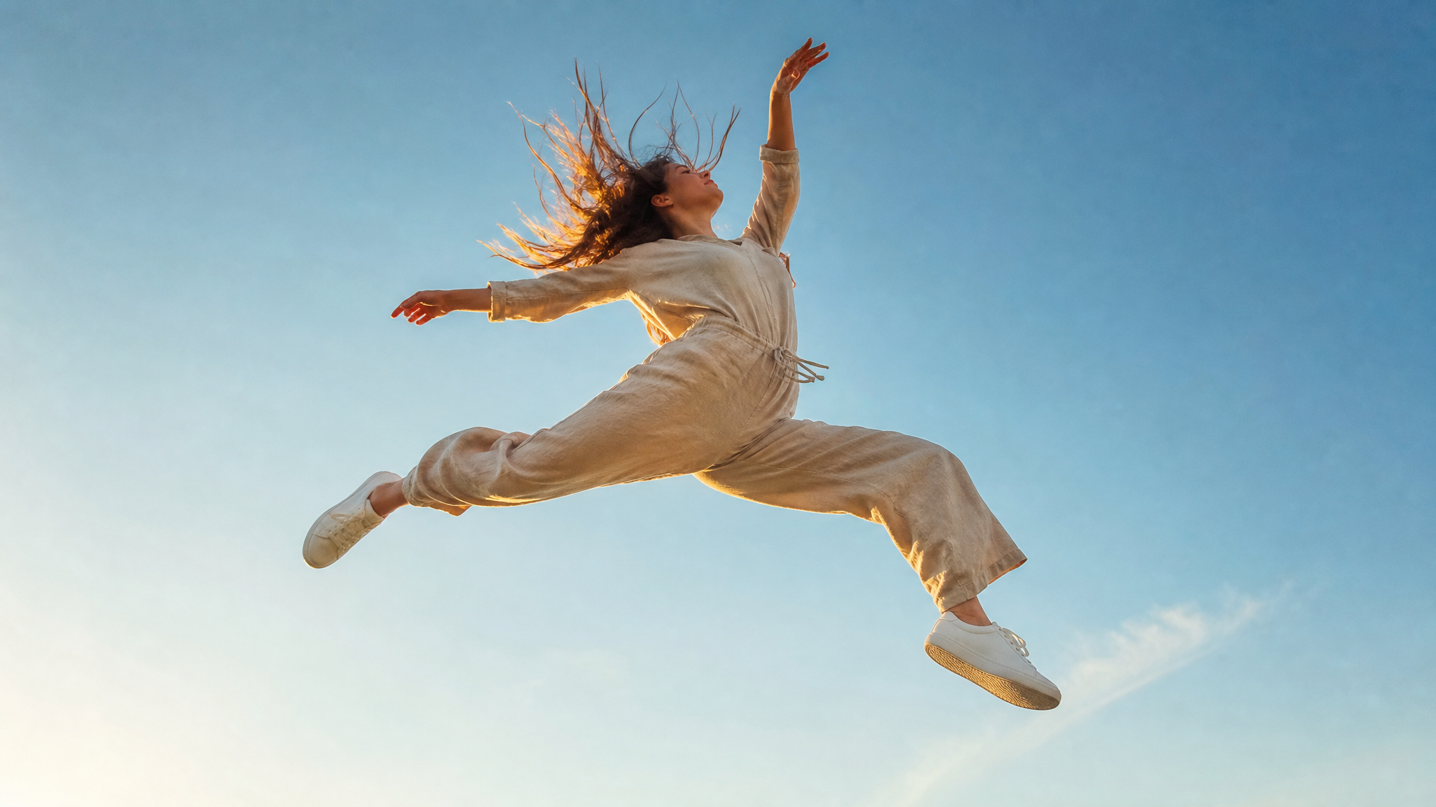 A young woman captured mid-air in a dynamic, gravity-defying