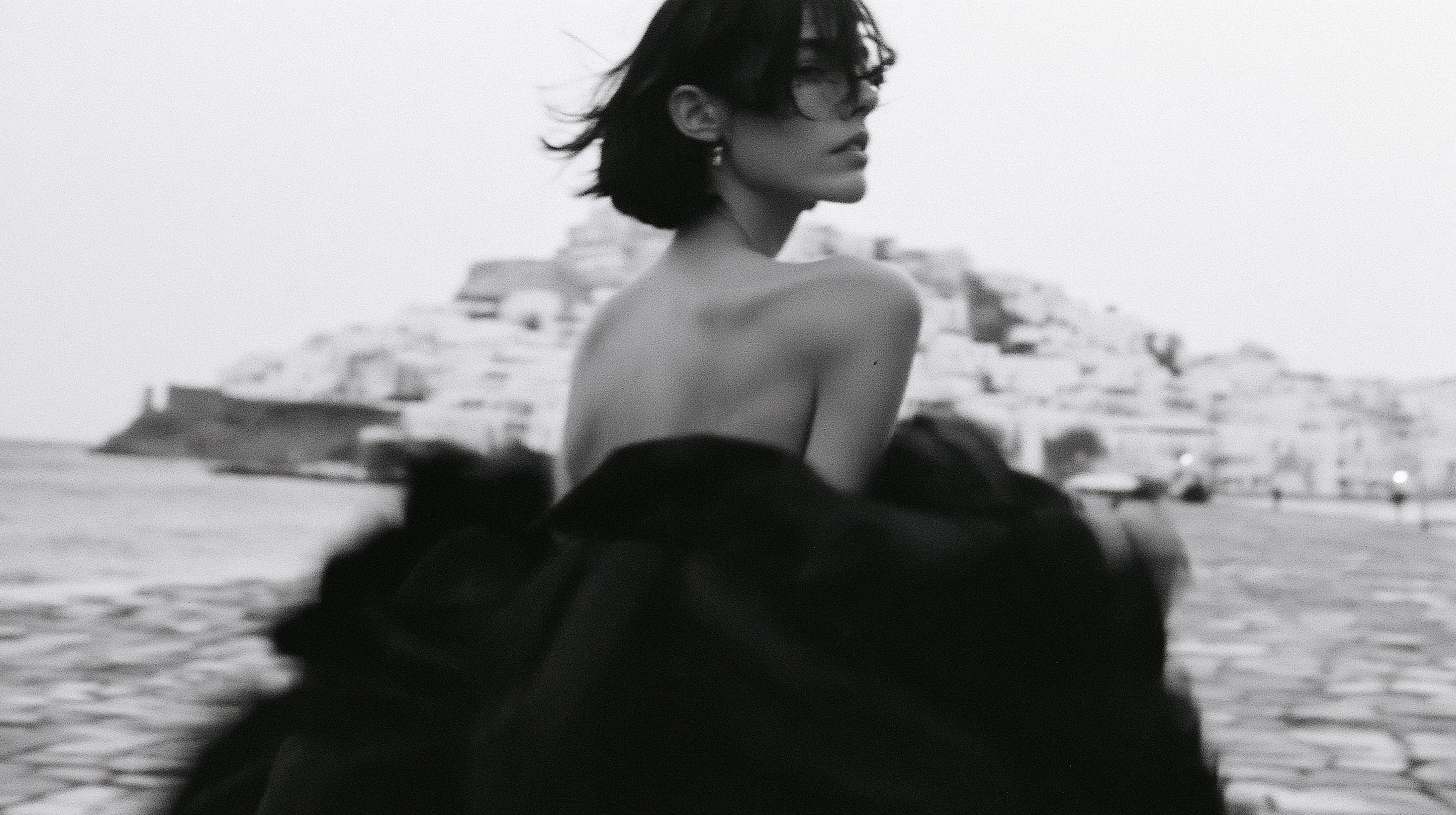 High-fashion black and white photo. A young woman with a sho